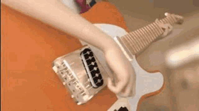 a close up of a person playing an electric guitar