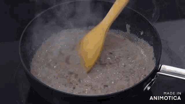a wooden spoon is stirring a sauce in a frying pan made in animatica