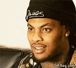 a man wearing a beanie that says drugs on it