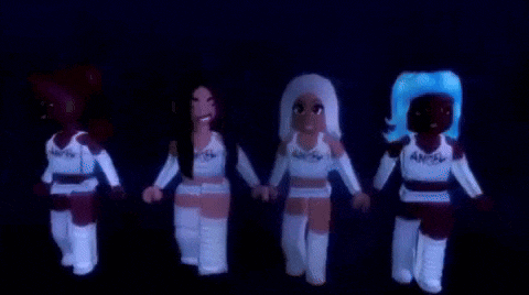 a group of girls are standing next to each other holding hands in the dark .