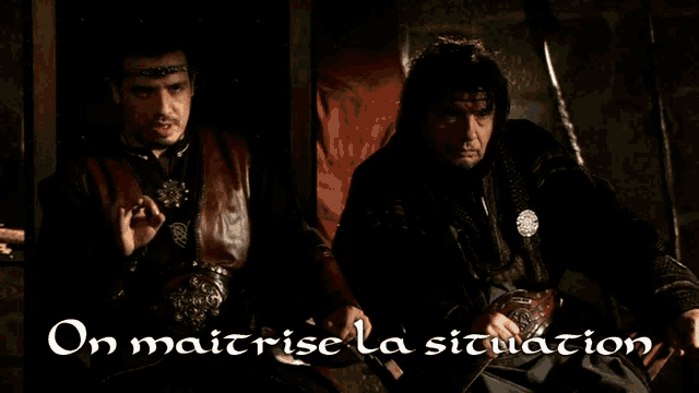 two men sitting next to each other with the words on maitrise la situation written below them