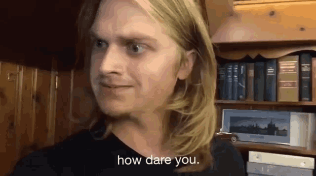 a man in a black shirt is asking how dare you