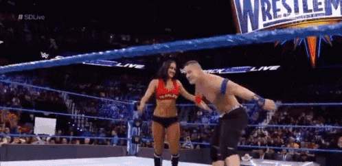 a man and a woman are wrestling in a wrestling ring
