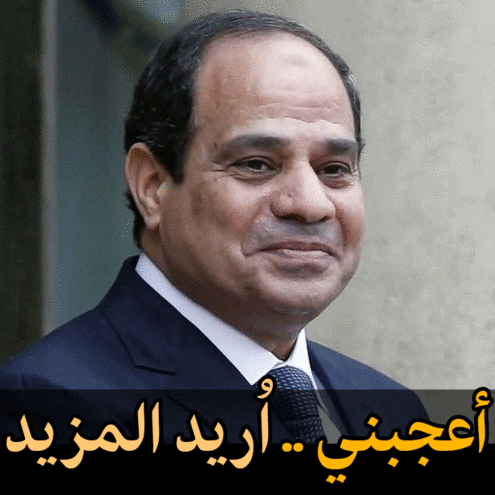 a close up of a man 's face with arabic writing behind him