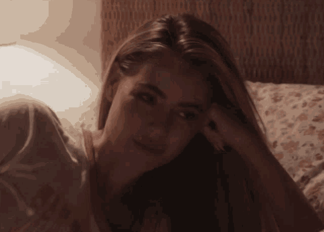 a woman laying on a bed with a t-shirt that says " i am " on it