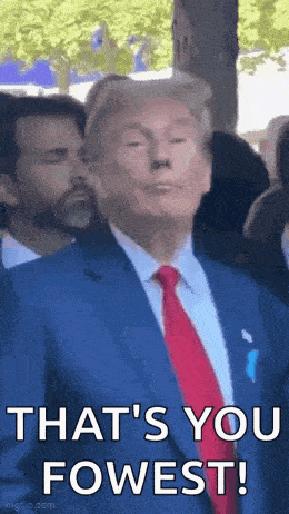 donald trump is wearing a suit and tie and making a funny face while standing in front of a crowd .