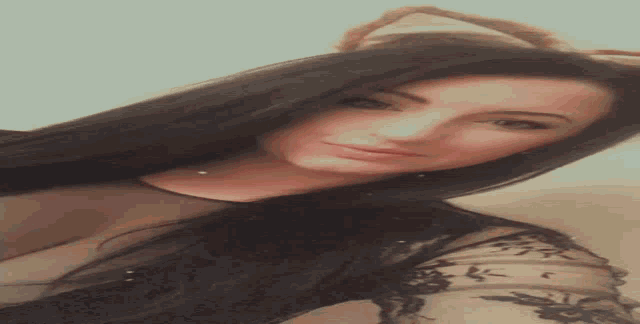 a woman with long black hair and cat ears is taking a selfie with her phone .