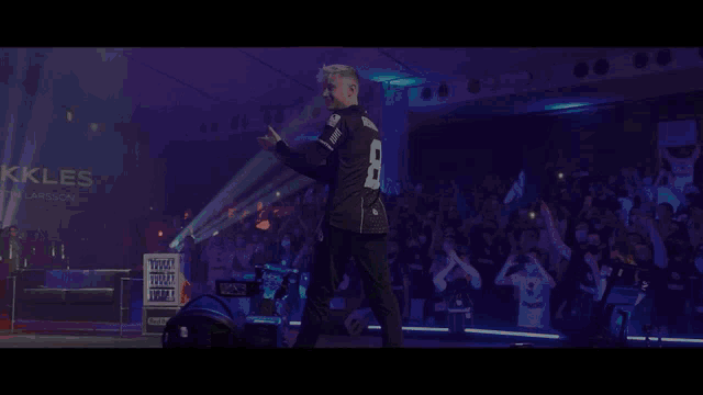 a man in a black shirt with the word king above him