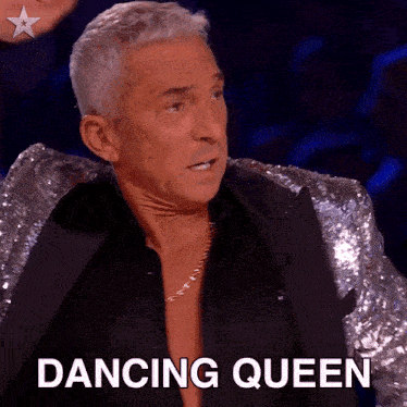 a man in a sequined jacket with the word dancing queen below him