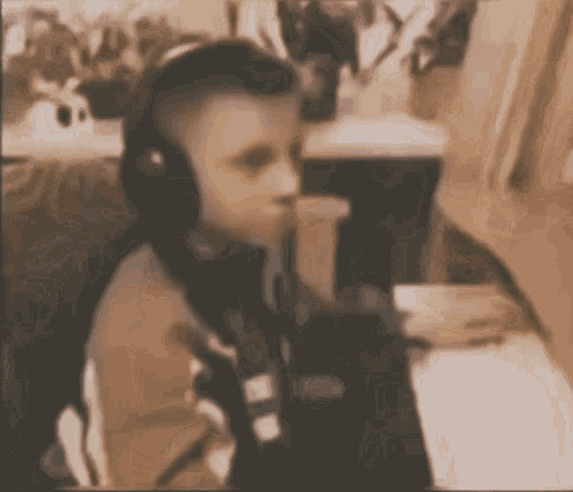 a blurry picture of a person wearing headphones sitting at a table