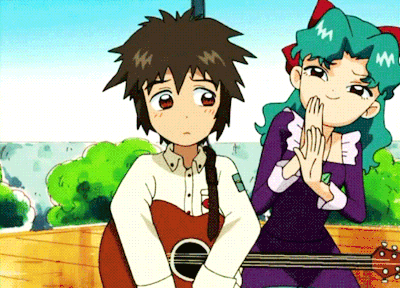 a girl with green hair is sitting next to a boy with brown hair