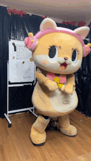 a mascot wearing headphones is standing in front of a whiteboard