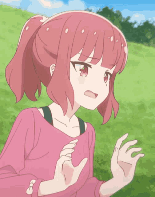 a girl with pink hair is making a funny face with her hands