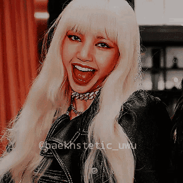 a woman with blonde hair is wearing a black jacket and a choker