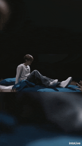 a person laying on a bed with the word intolive on the bottom left