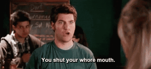 a man in a green shirt is talking to a woman and says `` you shut your whore mouth . ''