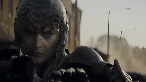 a close up of a person wearing a futuristic helmet