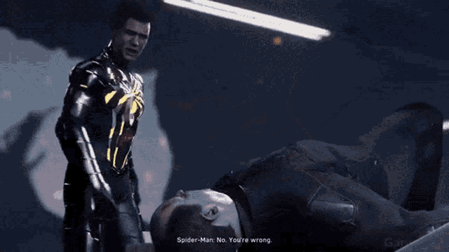 a man in a black suit with a spider on the back