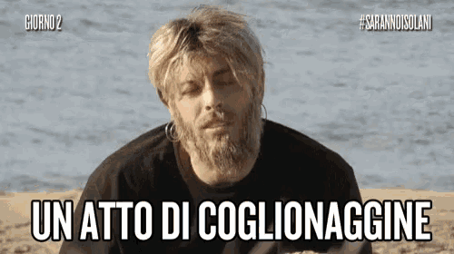 a man with a beard and earrings says un atto di coglionagine