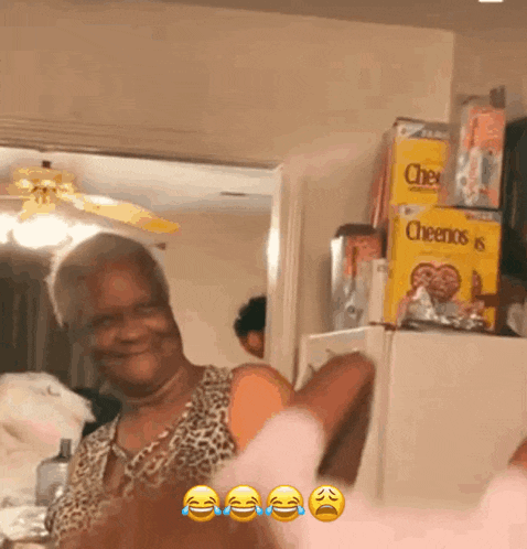 a woman laughs in front of a stack of cheerios boxes