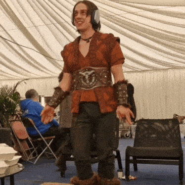 a man wearing a costume with a belt that says ' armour ' on it
