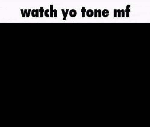 a person sitting in a dark room with the words " watch yo tone mf "