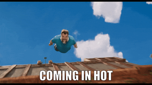 a man in a blue shirt is flying through the air with the words coming in hot below him
