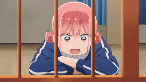 a girl with pink hair is behind a fence with her arms crossed