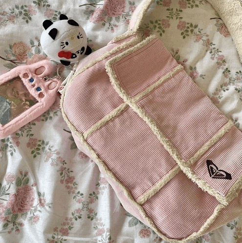 a pink purse with a butterfly embroidered on the front