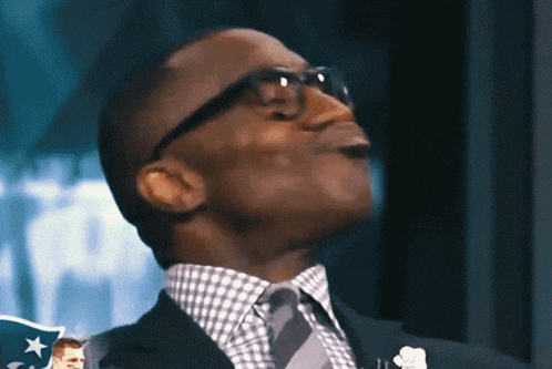a man in a suit and tie is looking up at something