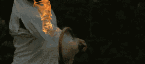 a person is holding a torch that is on fire