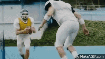 two football players are playing a game on a field .