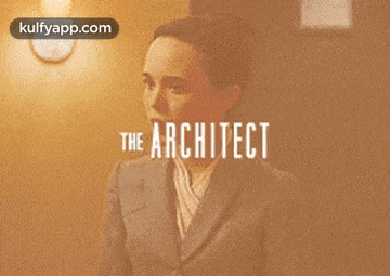 a woman in a suit stands in front of a wall with the words the architect on it