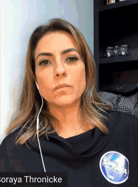 a woman wearing ear buds and a shirt that says nasa