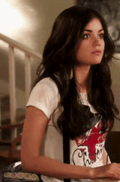 a woman wearing a t-shirt that says chuck taylor on it