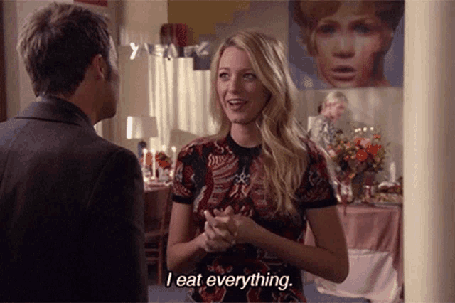 a woman says i eat everything while talking to a man in a room