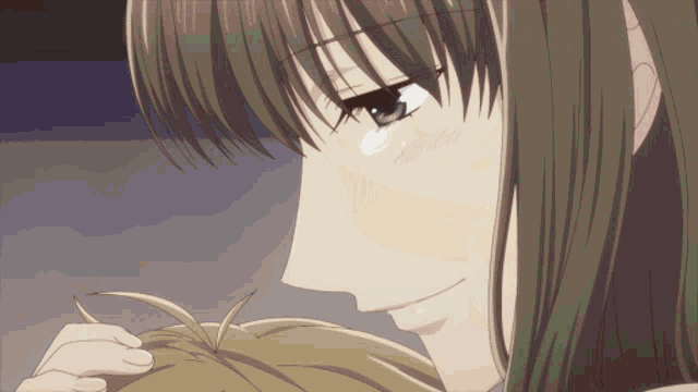 a close up of a woman 's face with a tear on her cheek