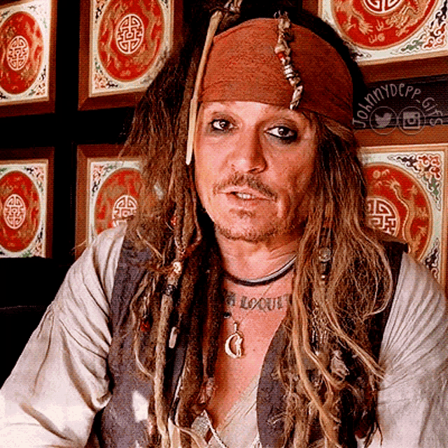 a man in a pirate costume has a tattoo on his chest that says " a loot "