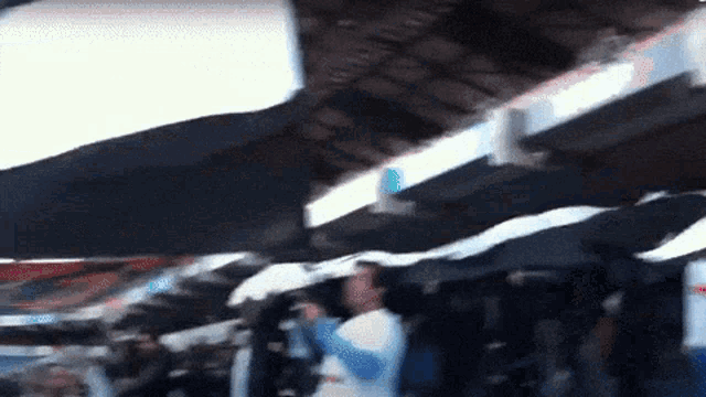 a blurry picture of a crowd of people holding umbrellas in the rain
