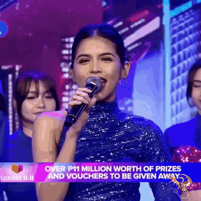 a woman is singing into a microphone with the words over p11 million worth of prizes and vouchers to be given away