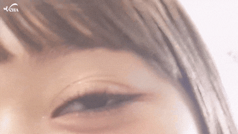 a close up of a woman 's eye with a veila logo in the corner