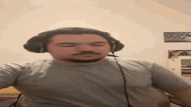 a man with a beard wearing headphones and a white shirt