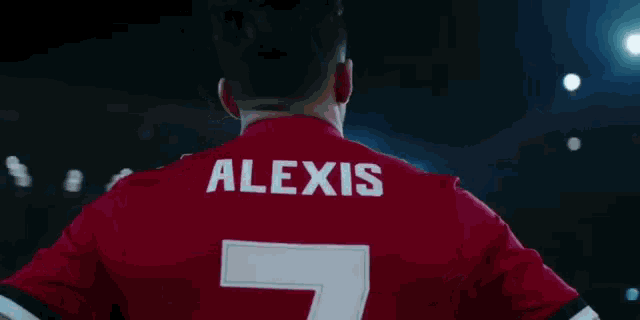 a soccer player wearing a red jersey with alexis on the back