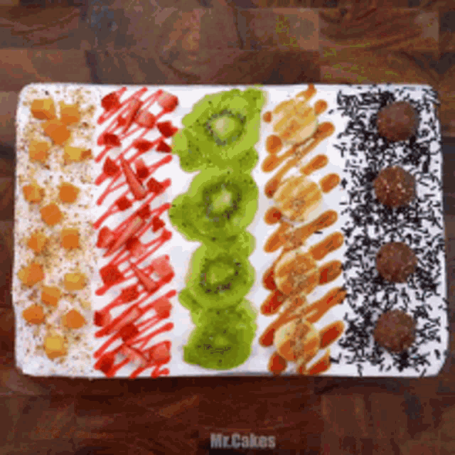 a tray of food with kiwi bananas and strawberries on it