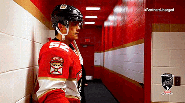 a panthers hockey player leaning against a wall