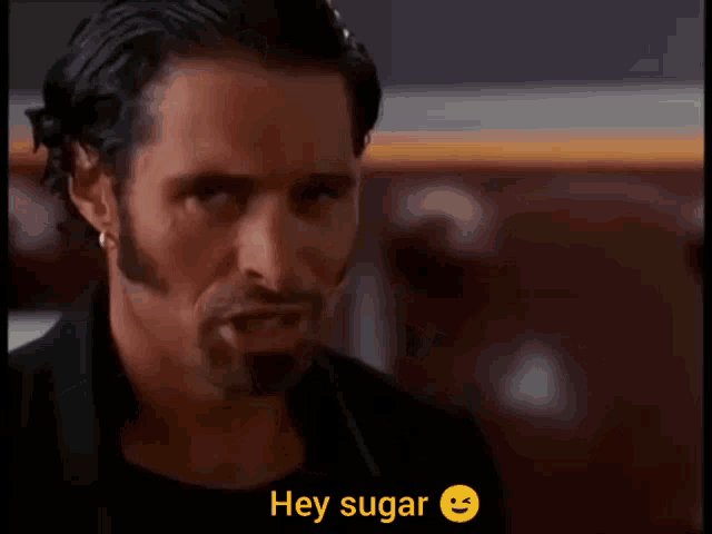 a man with a beard says hey sugar with a smiley face