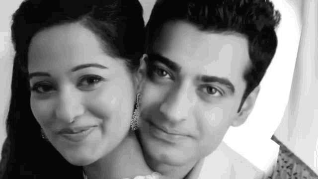 a black and white photo of a man and a woman posing for a picture