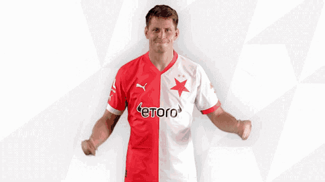 a man wearing a red and white jersey with etoro written on it