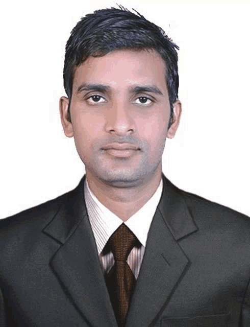 a man in a suit and tie poses for a photo