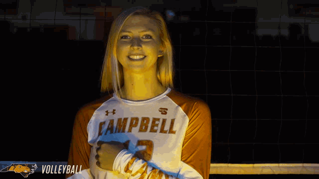 a woman wearing a campbell volleyball jersey